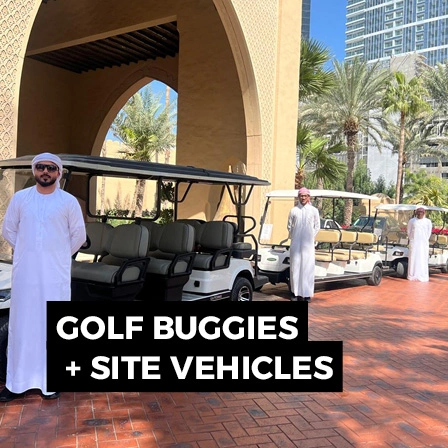 Golf buggies lined up at an outdoor event site for personnel and operational transport.
